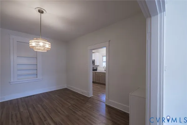 a view of a room with wooden floor fan and window