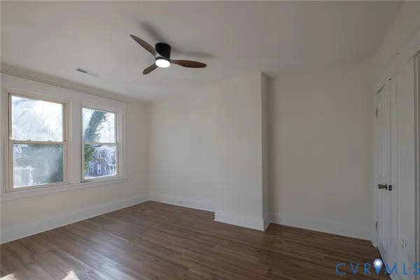 wooden floor in an empty room with a window