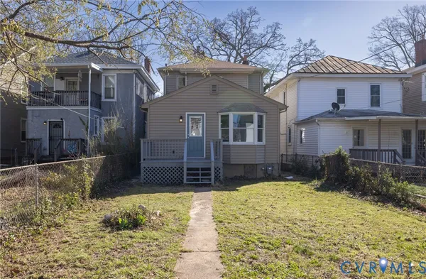 a aerial view of a house with a yard and balcony