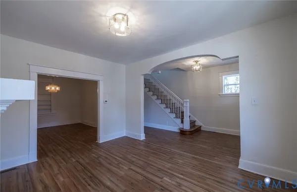 a view of a small space with wooden floor and a window