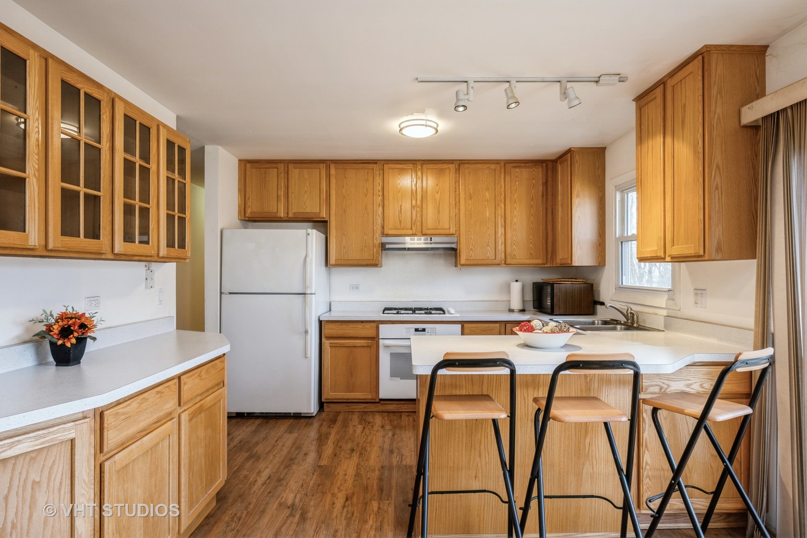 214 North School Street Cary, IL 60013 - Photo 3 of 11 a kitchen with stainless steel appliances granite countertop wooden cabinets a stove a sink a refrigerator and island with wooden floor