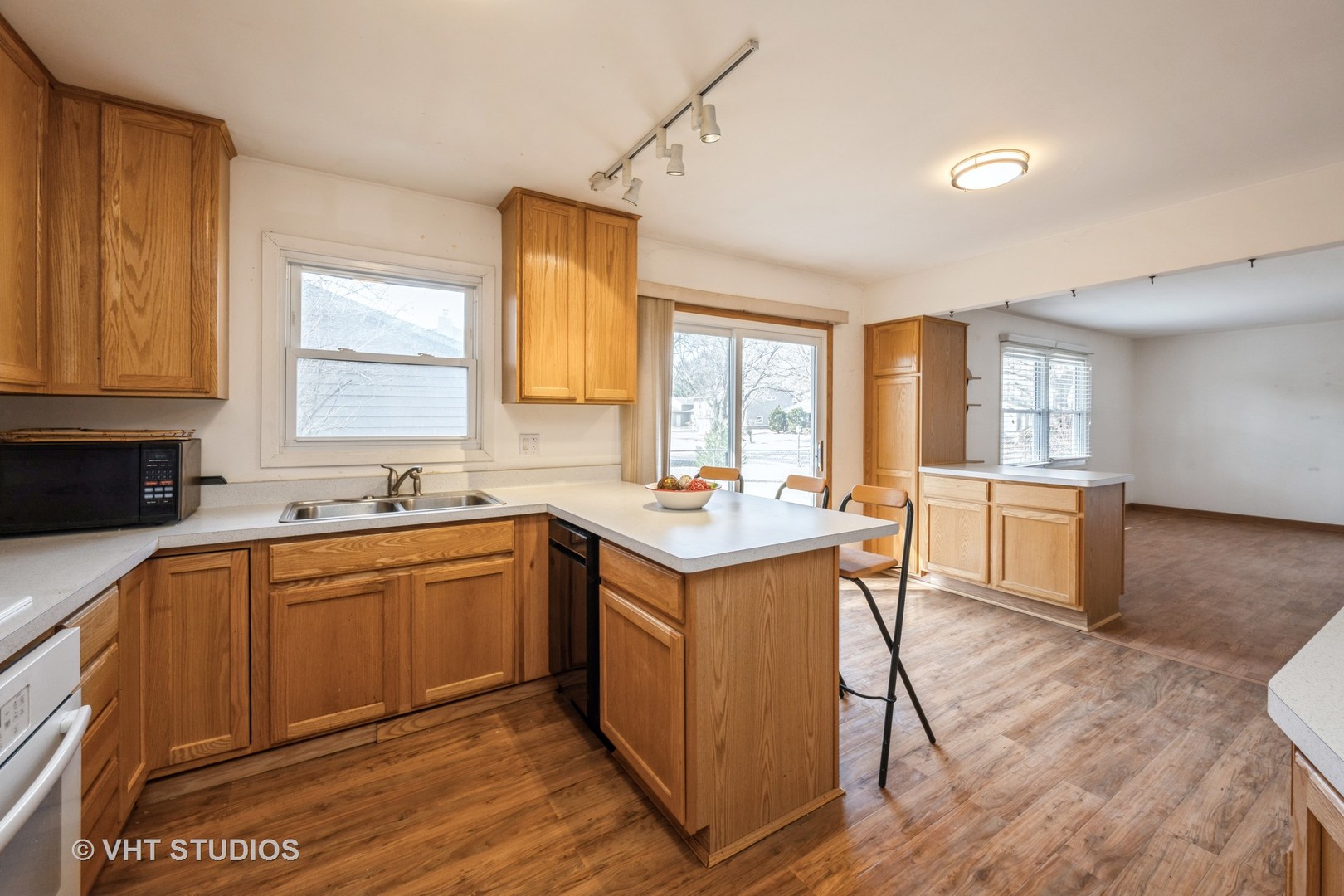 214 North School Street Cary, IL 60013 - Photo 4 of 11 a kitchen with stainless steel appliances granite countertop a sink a stove and a refrigerator