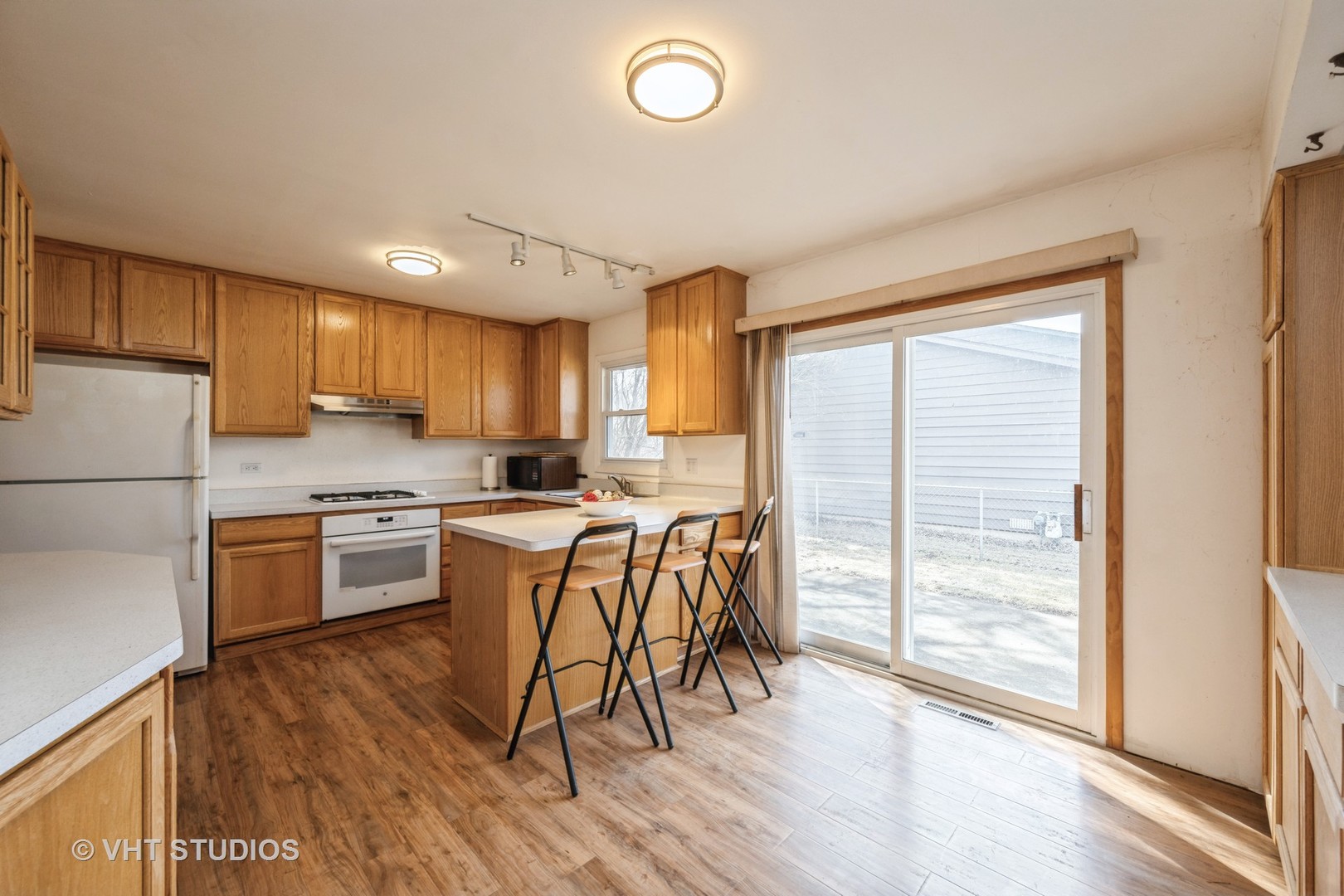 214 North School Street Cary, IL 60013 - Photo 5 of 11 a kitchen with wooden floors and appliances