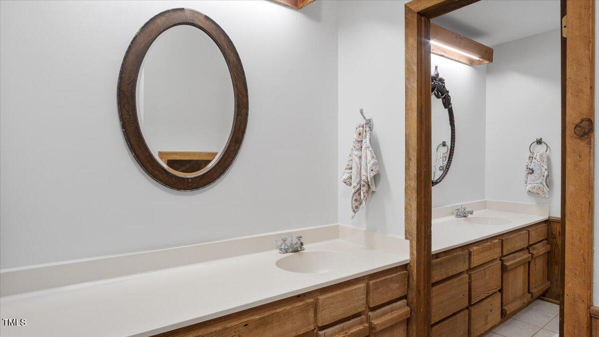 424 Roy Carver Road Semora, NC 27343 - Photo 25 of 68 a bathroom with a sink and a mirror