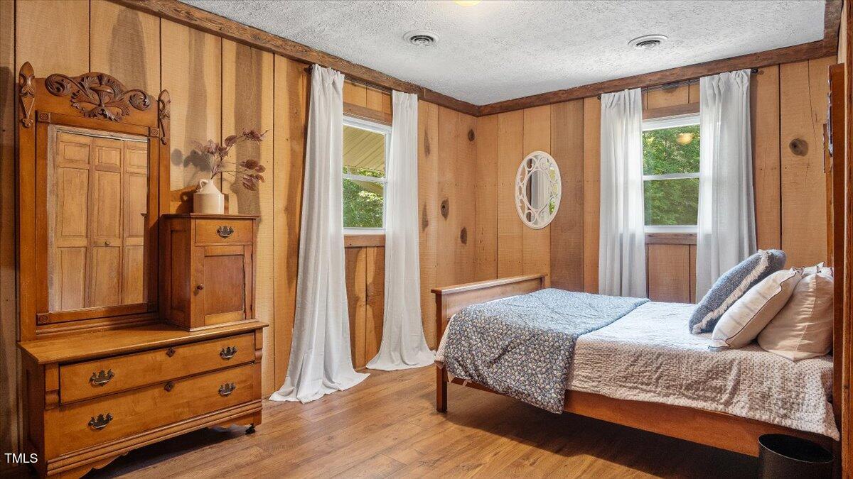 424 Roy Carver Road Semora, NC 27343 - Photo 31 of 68 a bedroom with a bed and a dresser