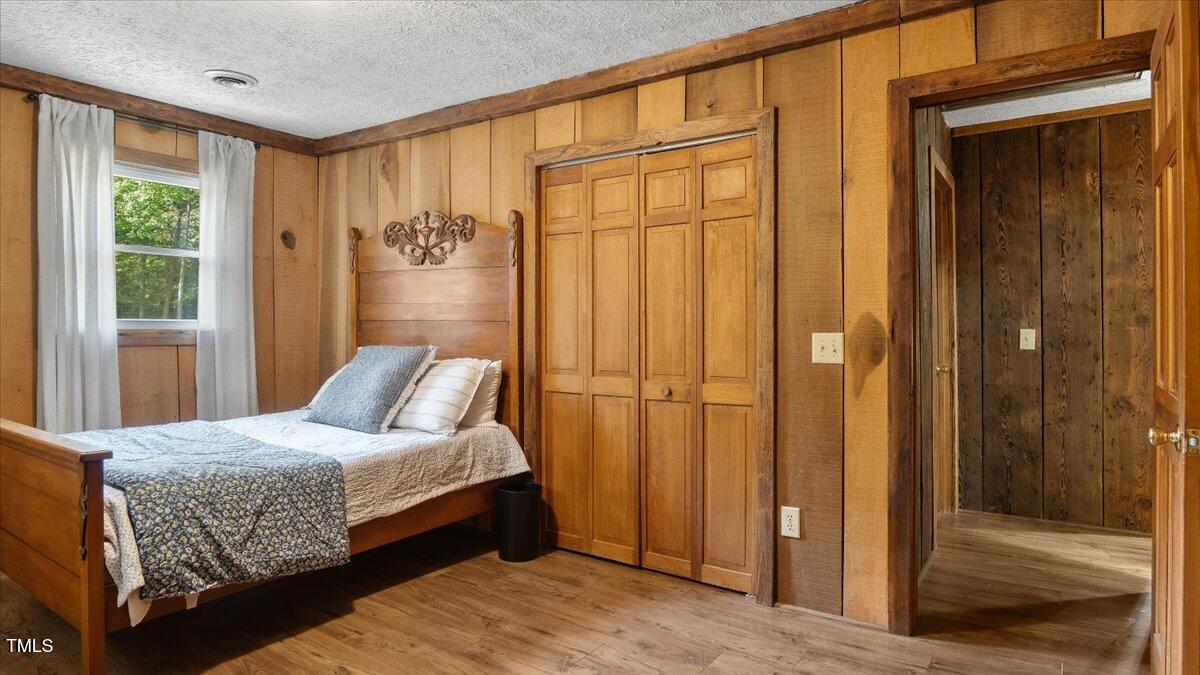 424 Roy Carver Road Semora, NC 27343 - Photo 32 of 68 a bedroom with a bed and a window
