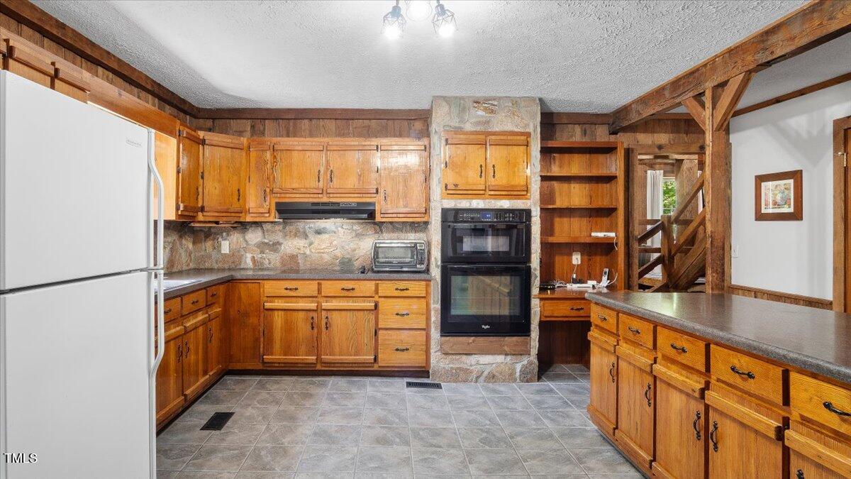 424 Roy Carver Road Semora, NC 27343 - Photo 39 of 68 a kitchen with stainless steel appliances granite countertop a refrigerator and a stove