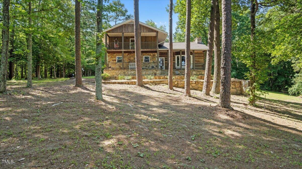 424 Roy Carver Road Semora, NC 27343 - Photo 3 of 68 a view of a house with backyard and trees