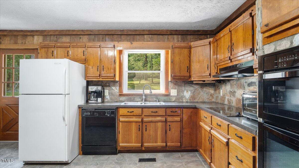 424 Roy Carver Road Semora, NC 27343 - Photo 42 of 68 a kitchen with a refrigerator a sink and cabinets