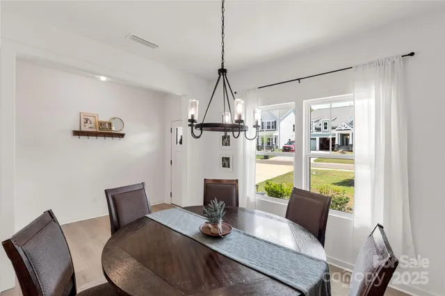 a living room with furniture a flat screen tv and a window