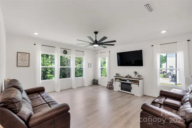 a living room with furniture floor and flat screen tv