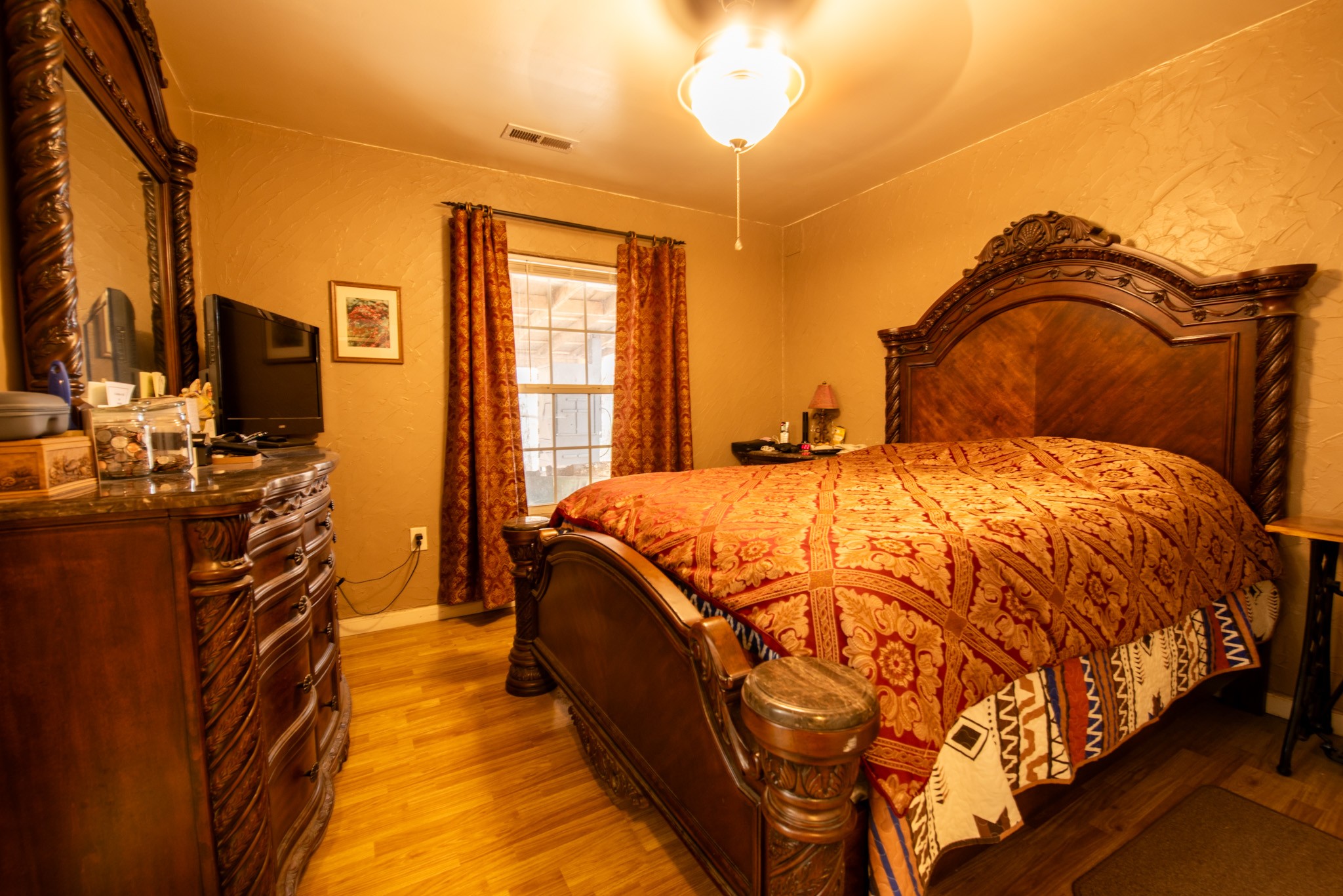 1286 David Patterson Road Lutts, TN 38471 - Photo 20 of 47 a spacious bedroom with a bed and a flat screen tv