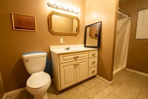 a bathroom with a toilet sink and mirror