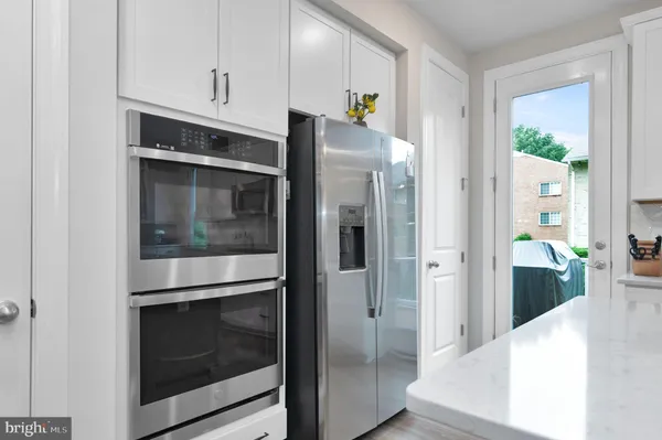a kitchen with stainless steel appliances a refrigerator and a stove top oven