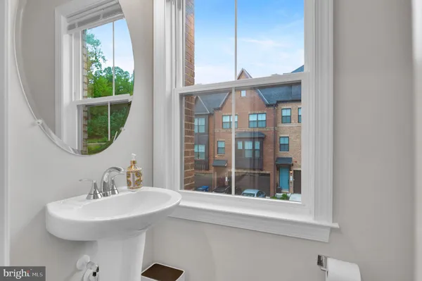 a bathroom with a sink a mirror and a window