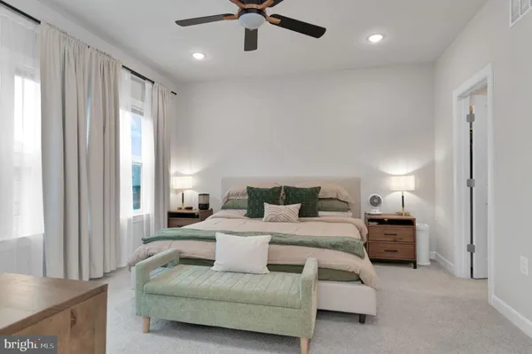 a bedroom with a bed and ceiling fan