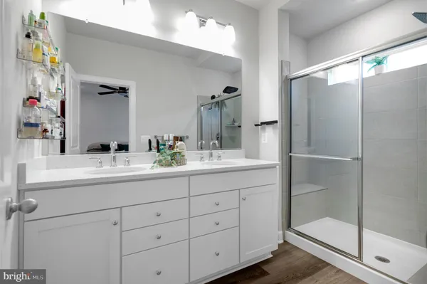 a bathroom with double vanity and a mirror