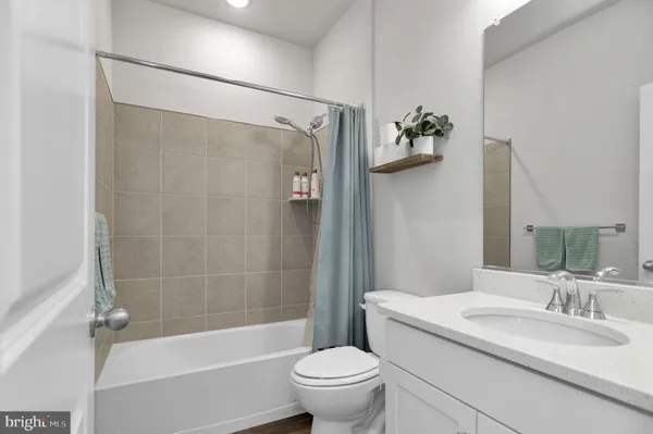 a bathroom with a sink a toilet and a bathtub