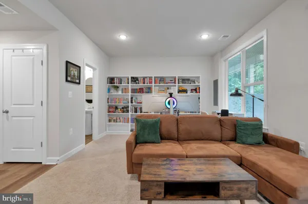 a bedroom with furniture and a book shelf