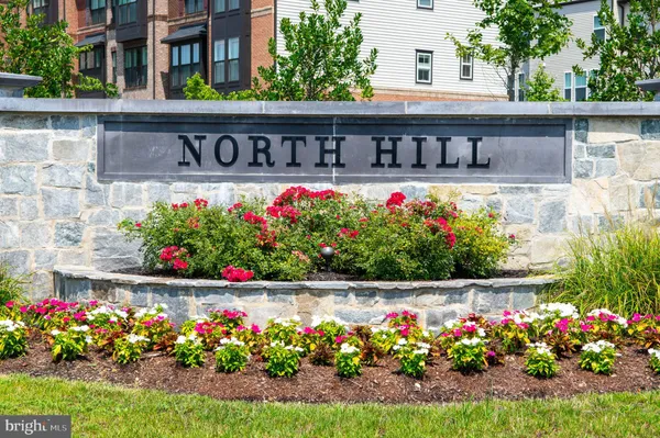 a view of sign board with buildings in the background