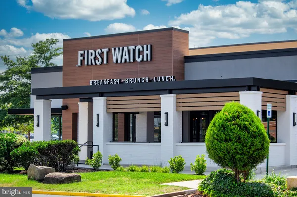 a front view of building with retail shops