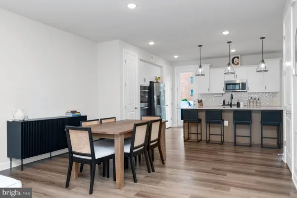 a view of a dining room with furniture and wooden floor