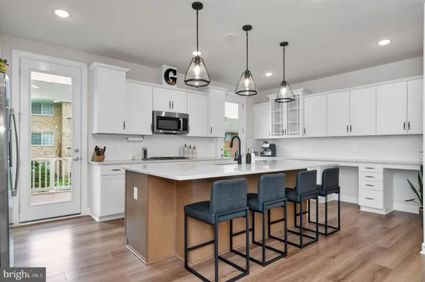 a large kitchen with stainless steel appliances kitchen island a large island in the center