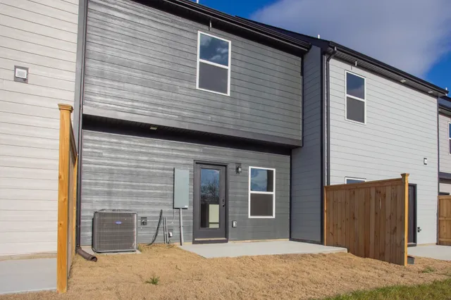 a view of a brick house with large windows