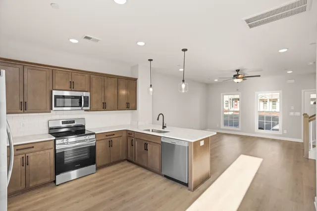 a kitchen with a sink stove and cabinets