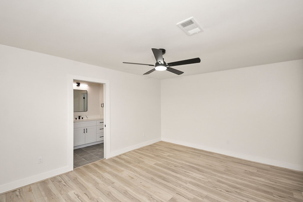 6106 Rutherglenn Drive Houston, TX 77096 - Photo 23 of 41 Additional view of the secondary bedroom with modern finishes, updated flooring, and abundant natural light.