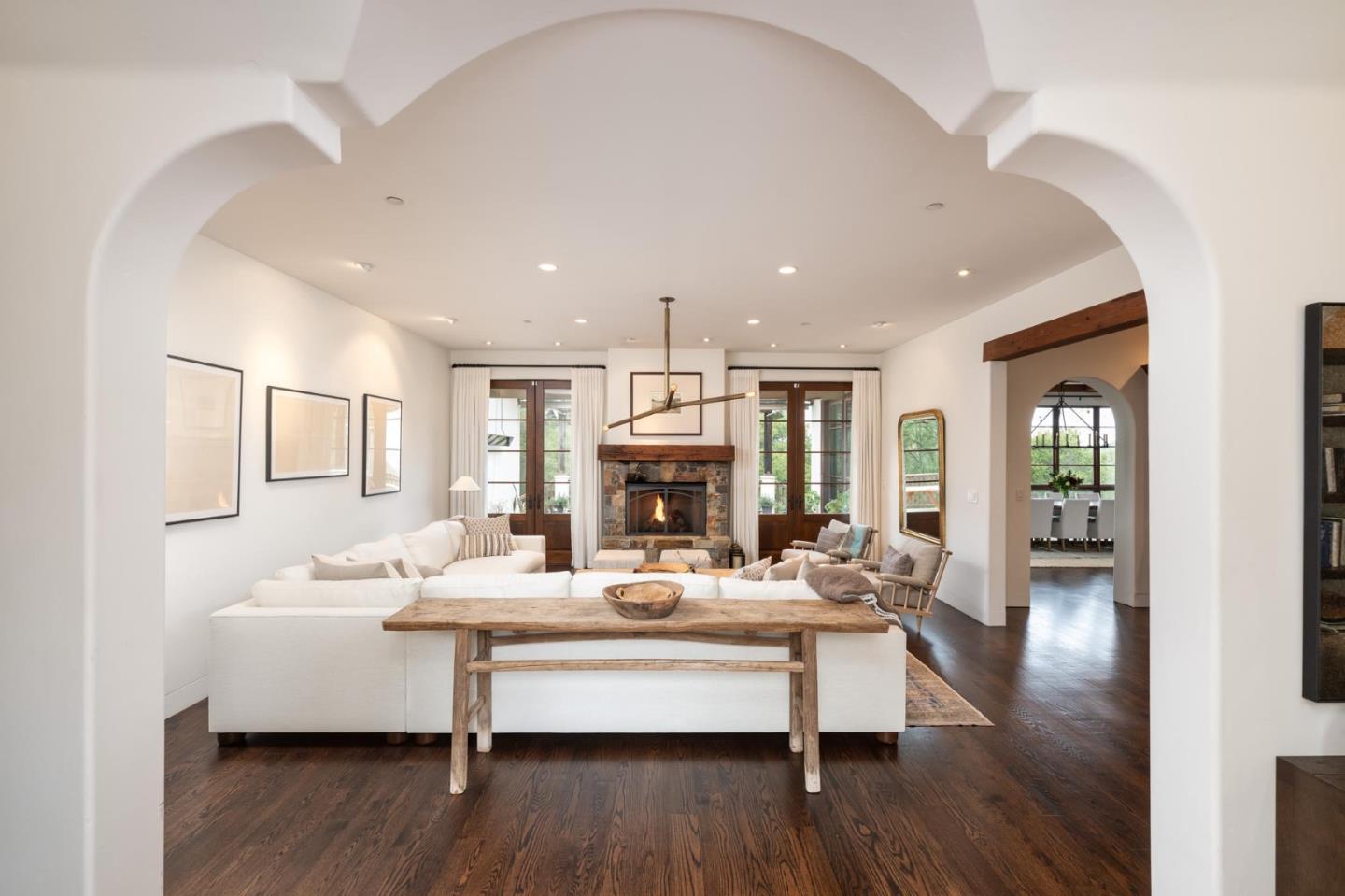 a living room with furniture fireplace and wooden floor