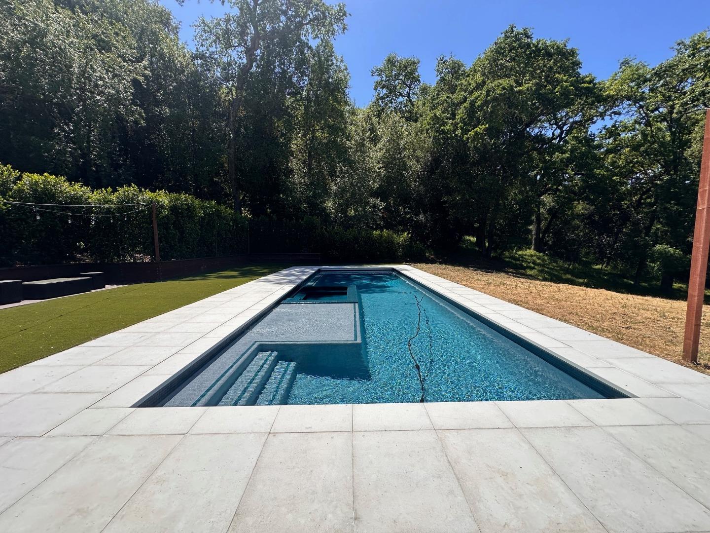 1036 Los Trancos Road Portola Valley, CA 94028 - Photo 26 of 33 a view of swimming pool with lounge chair and trees in the background