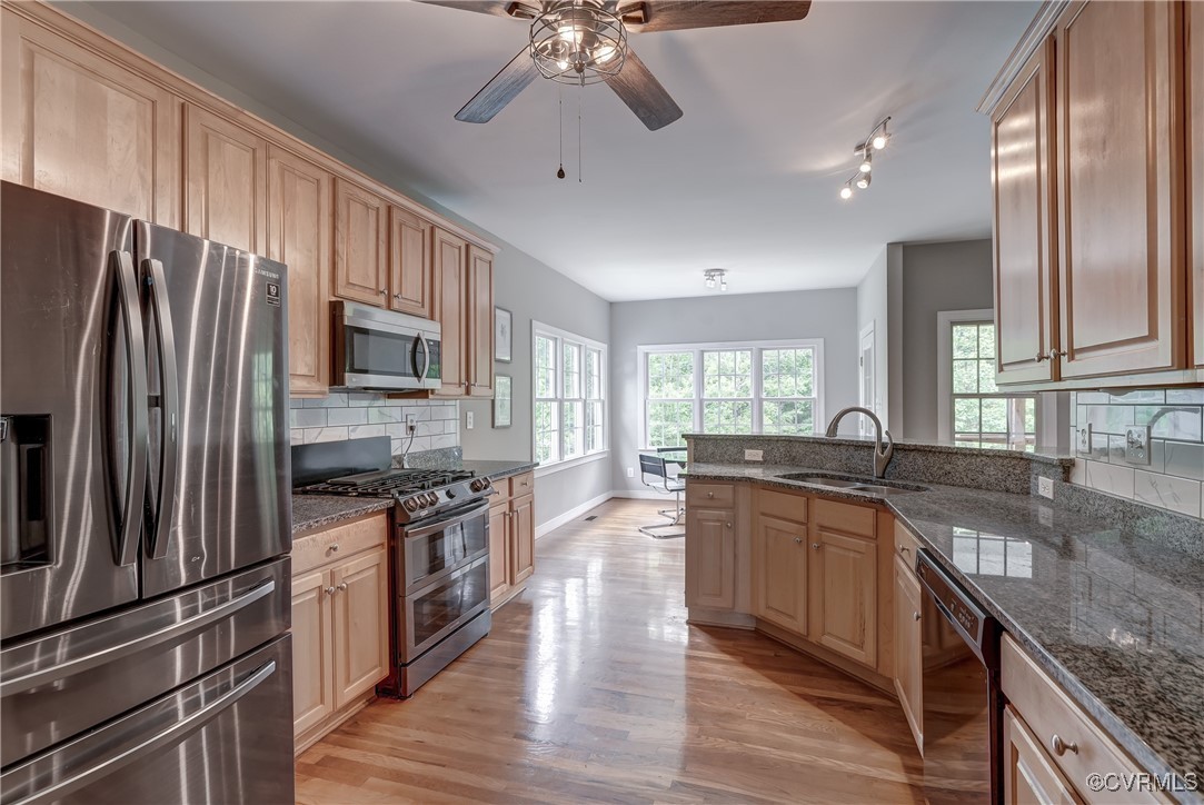 5501 Pine Needles Terrace Providence Forge, VA 23140 - Photo 17 of 50 a kitchen with stainless steel appliances granite countertop a sink stove microwave and refrigerator