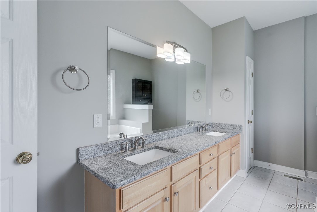 5501 Pine Needles Terrace Providence Forge, VA 23140 - Photo 23 of 50 a bathroom with a granite countertop sink and a mirror