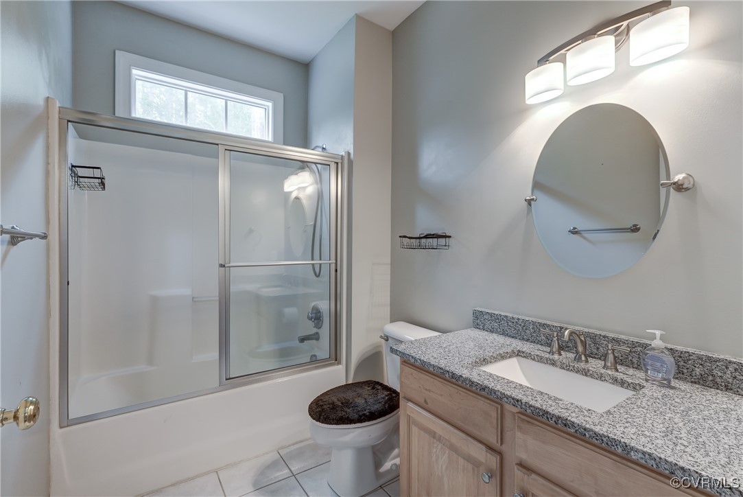 5501 Pine Needles Terrace Providence Forge, VA 23140 - Photo 29 of 50 a bathroom with a granite countertop sink a toilet and a mirror