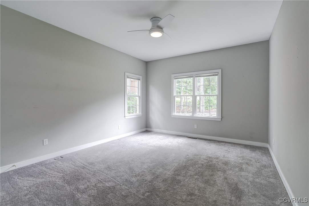 5501 Pine Needles Terrace Providence Forge, VA 23140 - Photo 31 of 50 an empty room with windows and ceiling fan