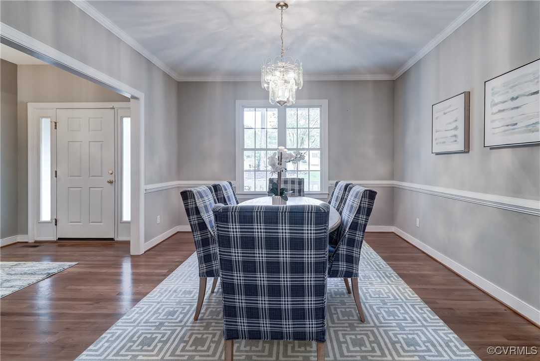 5501 Pine Needles Terrace Providence Forge, VA 23140 - Photo 5 of 50 a dining room with wooden floor a chandelier a wooden table and chairs