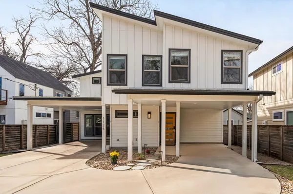 a kitchen with stainless steel appliances granite countertop a stove a sink and a dining table with wooden floor