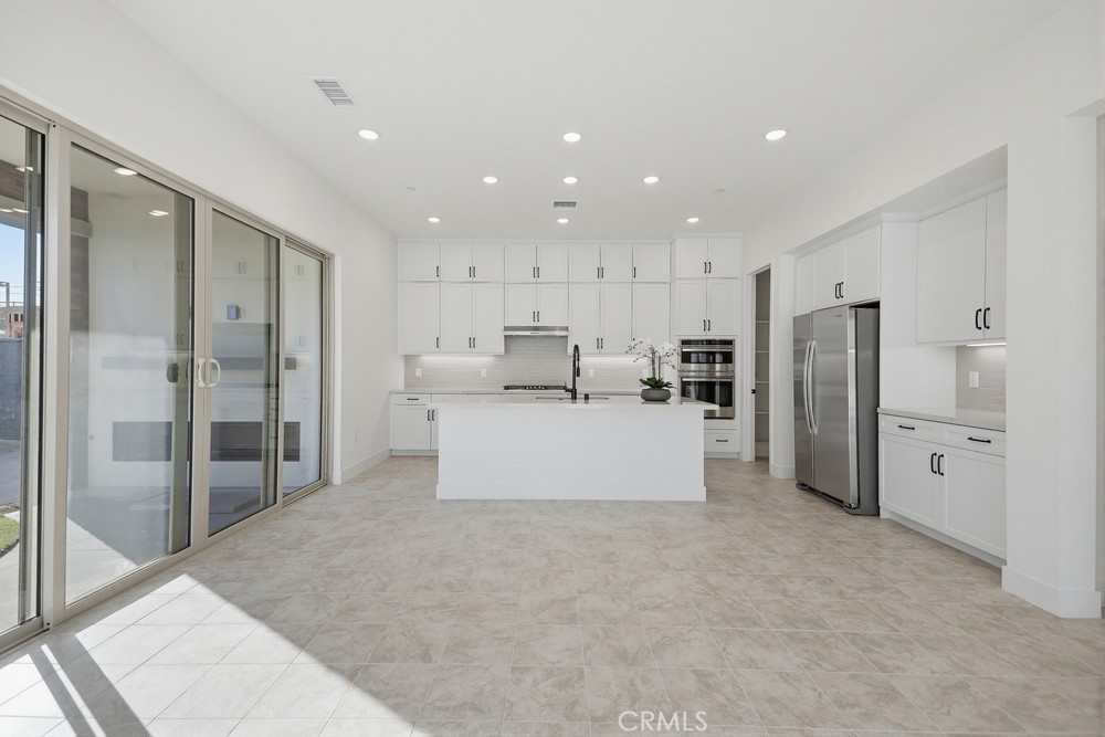 452 Botanica Rancho Mission Viejo, CA 92694 - Photo 16 of 53 a large white kitchen with a refrigerator and white cabinets