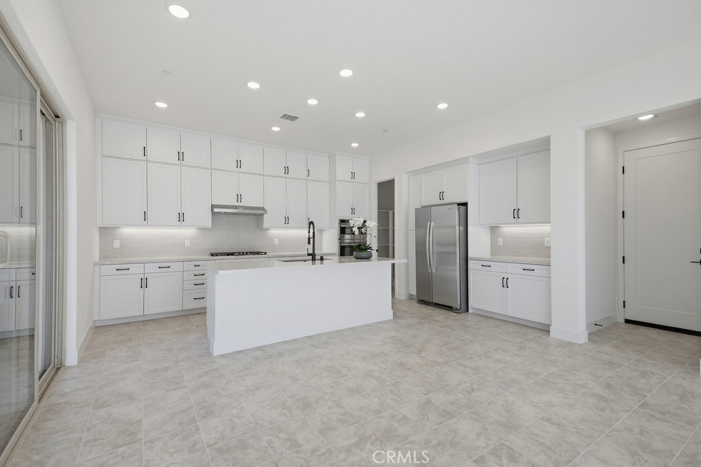 452 Botanica Rancho Mission Viejo, CA 92694 - Photo 17 of 53 a large white kitchen with white cabinets