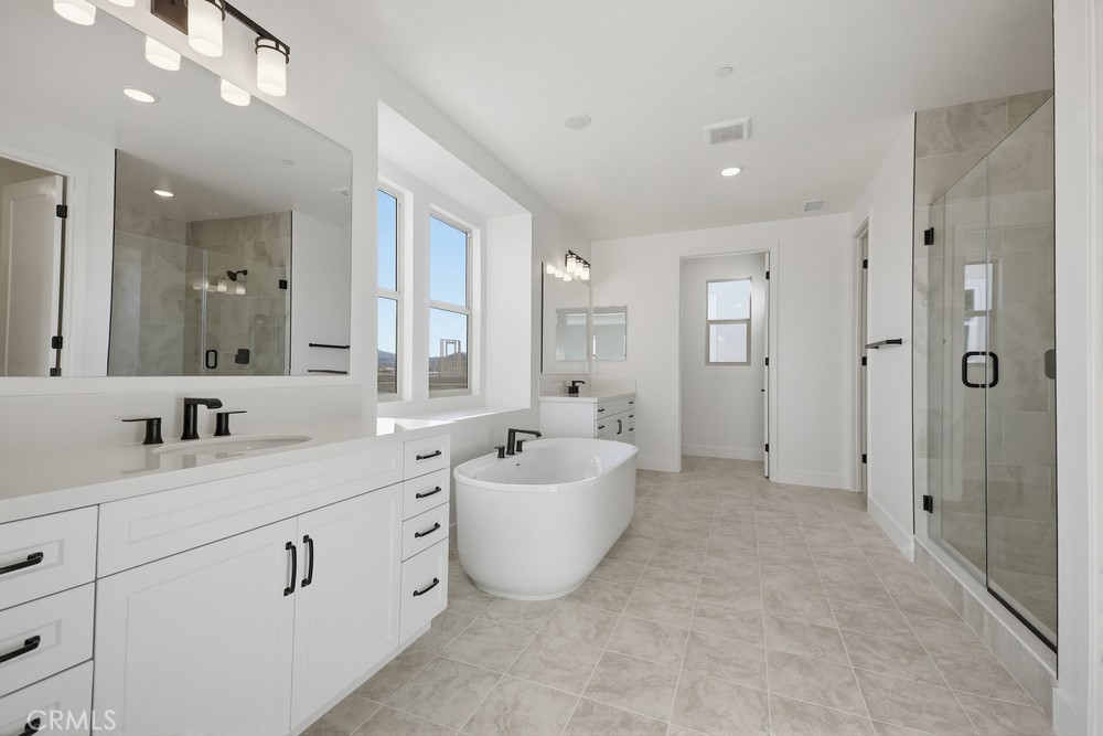 452 Botanica Rancho Mission Viejo, CA 92694 - Photo 26 of 53 a spacious bathroom with a double vanity sink mirror and shower