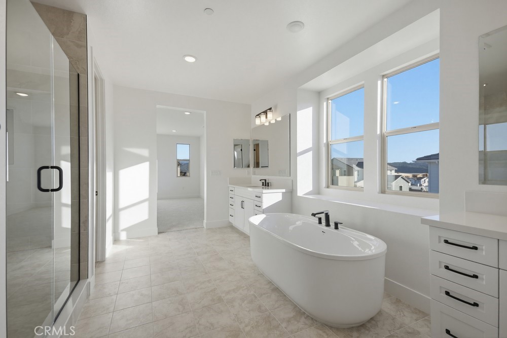 452 Botanica Rancho Mission Viejo, CA 92694 - Photo 29 of 53 a spacious bathroom with a tub sink shower and mirror