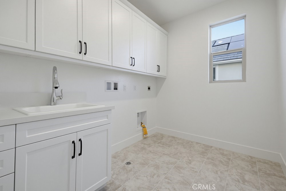 452 Botanica Rancho Mission Viejo, CA 92694 - Photo 37 of 53 a view of cabinets and utility room with racks on the wall