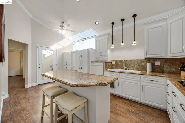 a kitchen with a table chairs and cabinets