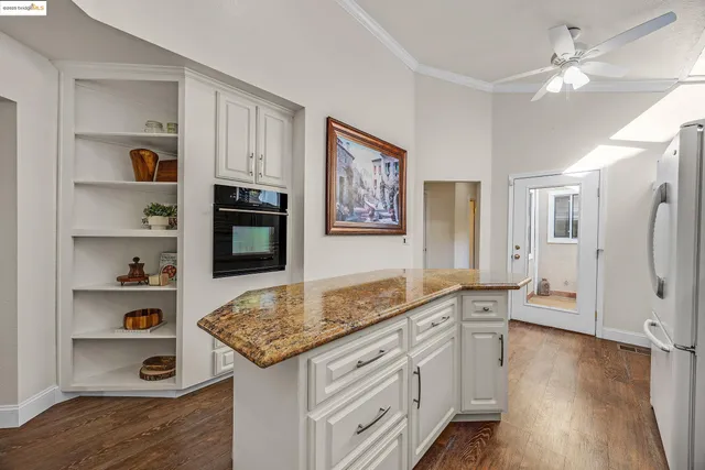 a kitchen with sink cabinets and wooden floor