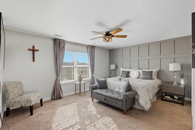 a spacious bedroom with a bed and a couch