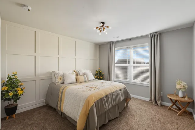a bedroom with a bed and a chandelier