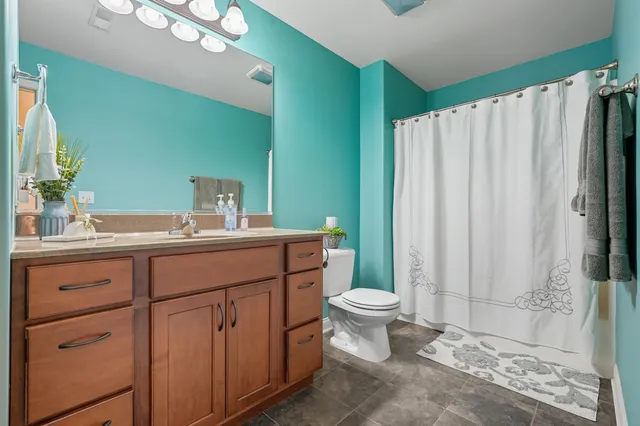 a bathroom with a toilet a sink and a mirror