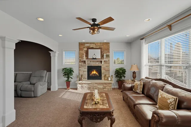 a living room with furniture and a fireplace