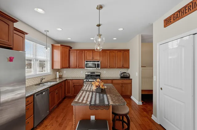 a kitchen with granite countertop a stove sink and cabinets